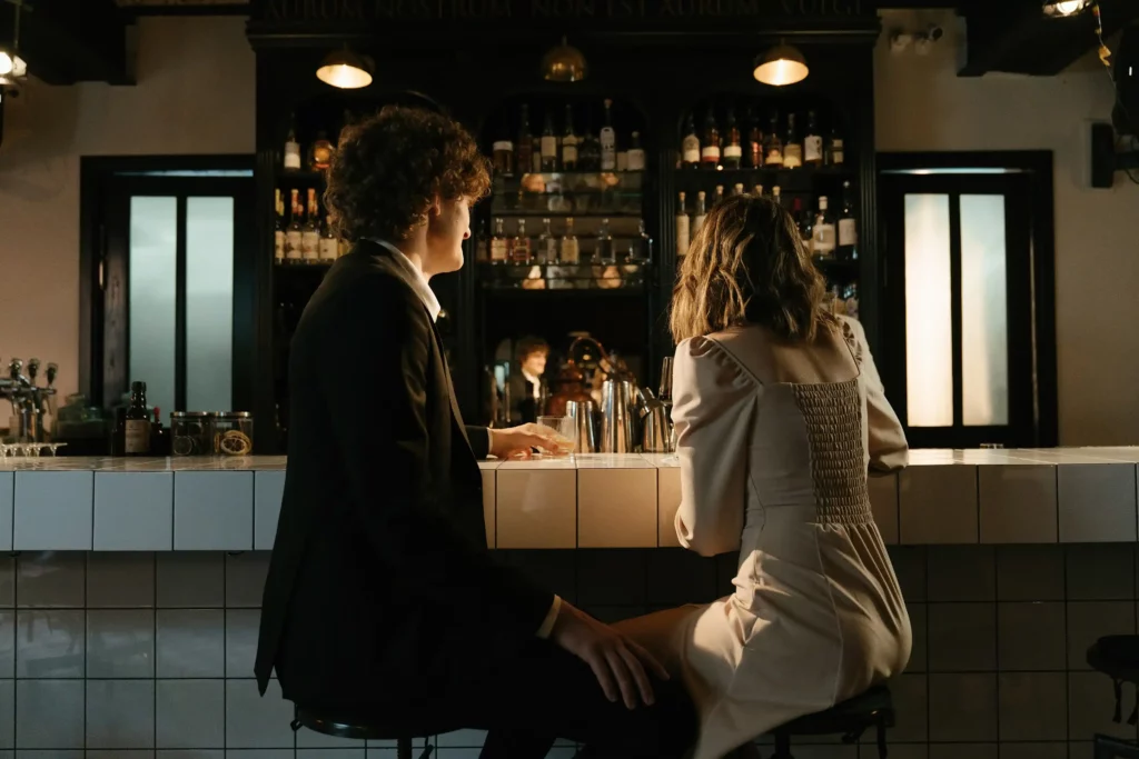 man and woman sitting at a bar